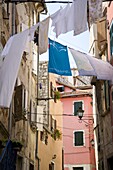 Laundry hanging in an alley of old buildings in Rovinj, Istria, Croatia, Europe
