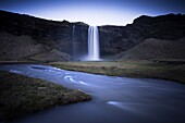 Seljalandsfoss Waterfall captured at dusk using long exposure to record movement in the water, near Hella, southern area, Iceland, Polar Regions