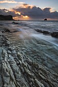 Incoming tide floods the rocky shore at sunrise Man O War Bay, Jurassic Coast, UNESCO World Heritage Site, Dorset, England, United Kingdom, Europe