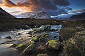 A boulder strewn stream meanders towards Buachaille Etive Mor, Highland, Scotland, United Kingdom, Europe