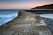 Dawn on the stone walls of The Cobb, Lyme Regis, Dorset, England, United Kingdom, Europe