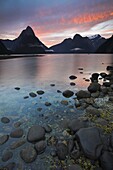 Fiery sky over Milford Sound at dawn, Fiordland National Park, UNESCO World Heritage Site, South Island, New Zealand, Pacific