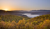 Autumn sunrise in Zagoria with the village of Kipi and a mist filled valley below, Epirus, Greece, Europe