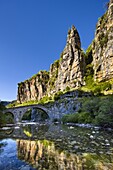 Towering cliffs and the 18th century Misius bridge over the Voidomatis River in the Vikos Gorge near Vitsa, Zagoria, Epirus, Greece, Europe
