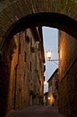 An early morning view through a stone arch in the hilltop town of Pienza, Val d'Orcia, UNESCO World Heritage Site, Tuscany, Italy, Europe