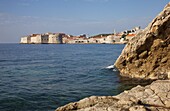 Rocky shoreline with Dubrovnik Old Town in the distance, Dubrovnik, Croatia, Europe