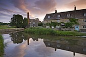 Cottages in the picturesque Cotswolds village of Lower Slaughter at sunrise, Gloucestershire, The Cotswolds, England, United Kingdom, Europe