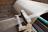 Silk thread being spun on large handmade wooden wheel, rural Orissa, India, Asia
