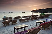 Beach restaurants at dusk on Ochheuteal Beach, Sihanoukville, Cambodia, Indochina, Southeast Asia, Asia
