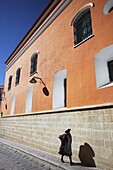 Woman walking along street, Potosi, UNESCO World Heritage Site, Bolivia, South America