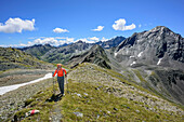Woman hiking ascending towards Gleirscher Rosskogel, Gleirscher Rosskogel, Sellrain, Stubai Alps, Tyrol, Austria