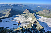 Woman climbing ridge Stuedlgrat towards Grossglockner, Stuedlgrat, Grossglockner, High Tauern, East Tyrol, Austria