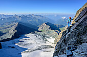Woman climbing ridge Stuedlgrat towards Grossglockner, Stuedlgrat, Grossglockner, High Tauern, East Tyrol, Austria