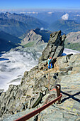 Woman climbing ridge Stuedlgrat towards Grossglockner, Stuedlgrat, Grossglockner, High Tauern, East Tyrol, Austria