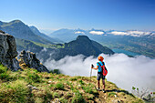 Woman ascending towards La Tournette, Lac d'Annecy in background, La Tournette, Haute-Savoie, France