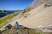 Woman hiking ascending towards Cima dell'Uomo, Cima dell'Uomo, Marmolada, Dolomites, UNESCO World Heritage Dolomites, Trentino, Italy