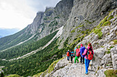 Several persons descending through valley Val Canali, Rifugio Pradidali, Pala range, Dolomites, UNESCO World Heritage Dolomites, Trentino, Italy