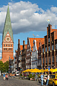 Lueneburg, Platz am Sande is the main square, tower of St John's church, outdoor cafés, stepped gables, Lower Saxony, Germany