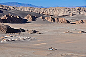 Jeep on track between mountains and rock formations, Valle de la Luna, Valley of the moon, Atacama desert, National Reserve, Reserva Nacional Los Flamencos, Region de Antofagasta, Andes, Chile, South America