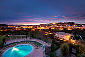 View towards old town, castle and cathedral at dusk, Silves, Algarve, Portugal