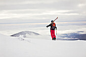 A backcountry skier takes in the view from Burnt Mountain, Maine.