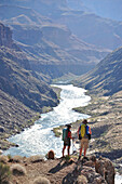 Hikers overlook the Colorado River as they follow a route that connect Tapeats Creek and Thunder River to Deer Creek in the Grand Canyon outside of Fredonia, Arizona November 2011.  The 21.4-mile loop starts at the Bill Hall trailhead on the North Rim and