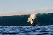 Surfer on a big barreling wave called El Quemao in Lanzarote, Canary Islands, Spain.