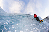 Climber on the icelandic glacier Solheimajokull during winter. South Iceland.