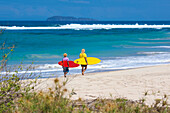 Surfers on a beach.Sumbawa island.Indonesia