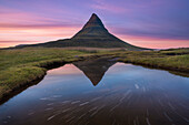 A reflection of Kirkjufell mountain on the Snaefellsnes peninsula in western Iceland.