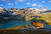 The Rudolfshut with the Weisssee mountain lake, one of the huts hikers stay at during the Glocknerrunde, a 7 stage trekking from Kaprun to Kals around the Grossglockner, the highest mountain of Austria.     Located in the heart of the Hohe Tauern National