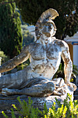 Stone statue of reclining figure of Dying Achilles (Achilleas thniskon) at Achilleion Palace, Museo Achilleio, in Corfu, Greek Islands, Greee, Europe