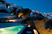 A swimming pool on a terrace at dusk, Oia, Santorini, Cyclades, Greek Islands, Greece