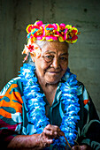 A Niue weaver wearing leis, Niue