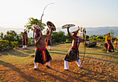 Manggarai men wearing traditional headdress wrapped with cloth using shields and bamboo whips in a caci, a ritual whip fight, Melo village, Flores, East Nusa Tenggara, Indonesia