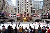 People Ice Skating In The Rockefeller Center Ice Rink, Midtown Manhattan, New York, Usa