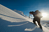 Walker with ice axe going through heavy snow up Beinn Respiol, Ardnamurchan peninsula, Highlands, Scotland