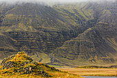 'The mountains along the south coast of Iceland run with waterfalls during the heavy rains that buffet the coast; Iceland'