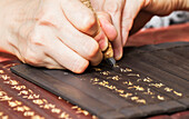 Woman carving inscriptions on wooden panels, Xidi, Anhui, China