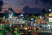 Mit LED Lichtern geschmueckte Haeuser an Hauptstrasse Subhas Bazaar, Taxis, Divali Lichterfest am 2.11.13, grosses Dorf Diglipur, North Andaman, Andaman Islands, Union Territory, India