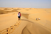 Sultanate of OMAN the Rub al Khali desert,a group of tourists is walking in the middle of the sand desert