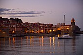 Europe, France, Languedoc Roussillon, Pyrenees Orientales, Collioure, the village and the church of Notre Dame des Anges at dusk