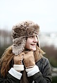 Portrait of a teenage girl wearing a fur hat
