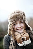 Portrait of a teenage girl wearing a fur hat