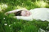 Portrait of a 9 years old girl elongated in the grass