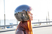 Caucasian woman wearing motorcycle helmet