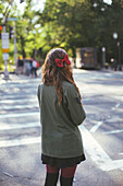 Caucasian woman crossing city intersection