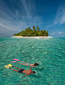 Caucasian couple snorkeling off tropical island
