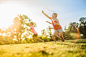 Girls blowing bubbles in grass field