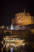 Illuminated boat floating on river, Rome, Italy